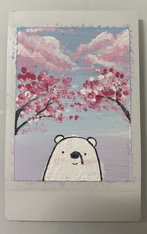 A photo of painting of a white bear standing under Cherry Blossom Trees.