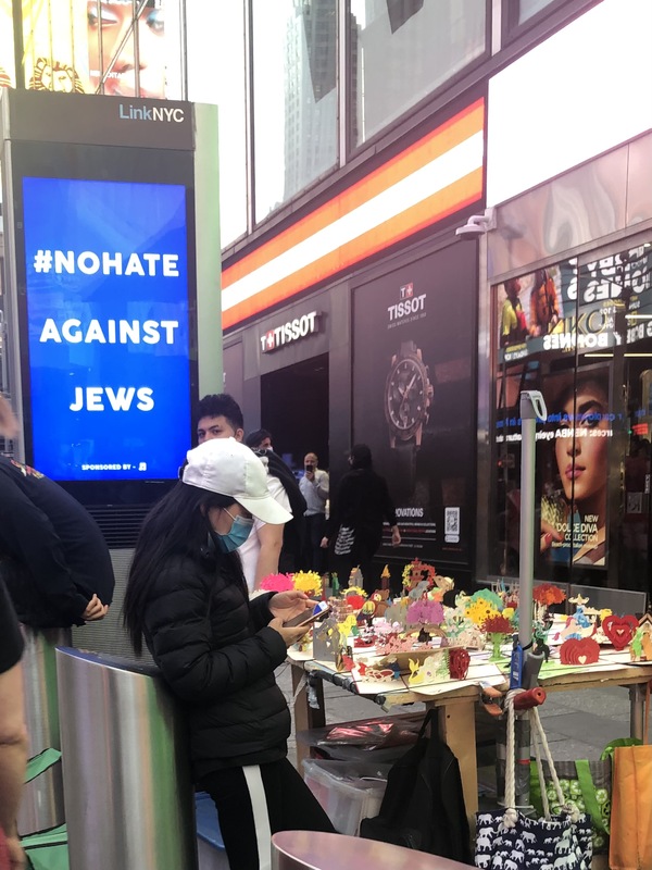 This is a picture of a sign next to an arts and crafts table that reads: "#Nohate against Jews." 
