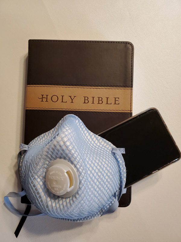 A bible, a phone, a mask. 