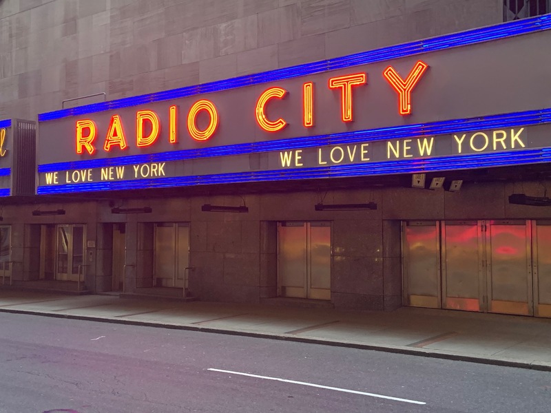 A building with a sign that reads "Radio City". 