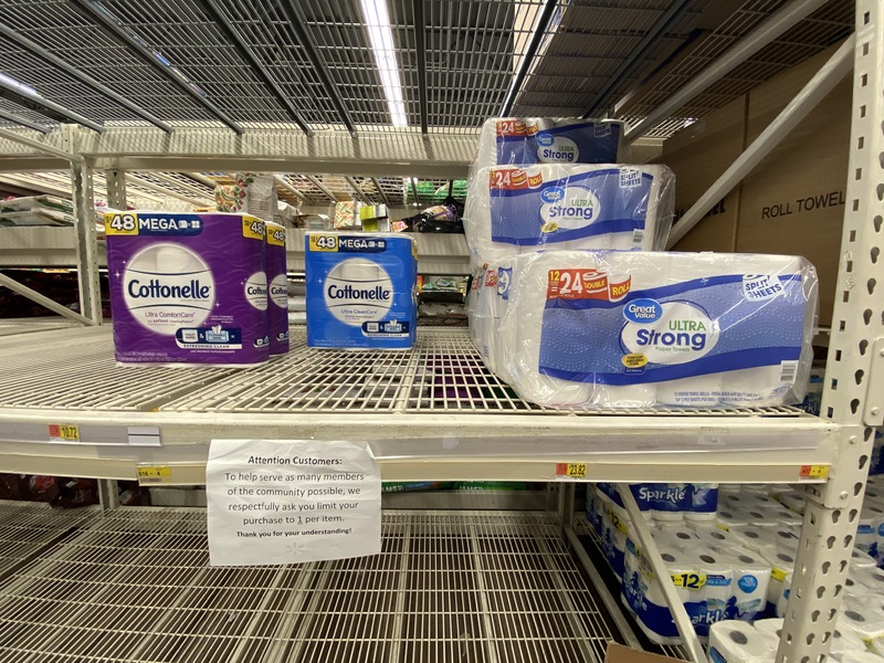 Photo of an almost empty toilet paper aisle at a store.