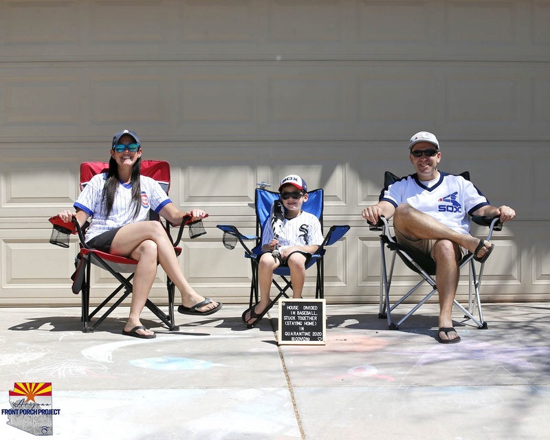 A family sitting on lawn chairs. 