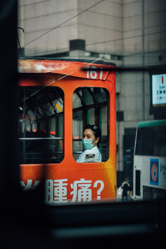 A woman sitting in a tram car. 