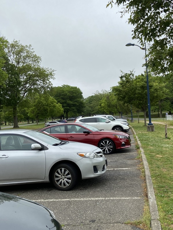 A photo of a parking lot with several cars in it.
