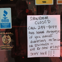 A handwritten sign saying:
"Showroom closed. Call 294-9044 and leave message if you have questions on service or install- will reopen ASAP. Stay well!"