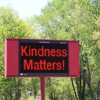 Digital sign reading "Kindness Matters".