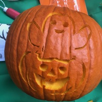 Orange pumpkin carved with ghost for Halloween.