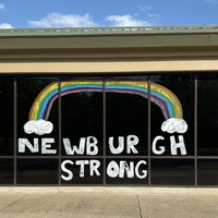 Window writing reading "Newburgh Strong" as well as a rainbow.