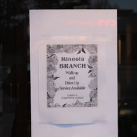 Sign that says: "Mineola Branch. Walk up and drive up service available. Lobby is currently closed." 