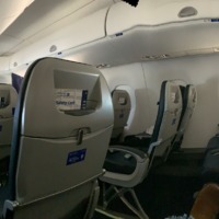 Picture of empty seats on an airplane during flight.