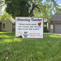 A yard sign reading "Amazing Teacher: Whether Here or There, We Teach Because We Care".