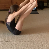 A child stretching and doing gymnastics. 