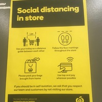 Yellow paper with text,  "Social distancing in store." There are four pictures about how to social distance. First one has two people and a trolley measuring 1.5 meters distance between them. Second shows floor markings that will be throughout the store. Third asks to pack the bags you brought from home. Fourth asks you tap to pay when possible. Text at bottom says, "If you should be in self-isolation, we ask that you respect our team and customers by not visiting our store."
