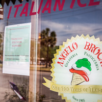 A closed sign is posted in the front window of Angelo Brocato’s Gelateria in New Orleans, LA.