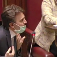An Italian councilor wearing a mask.