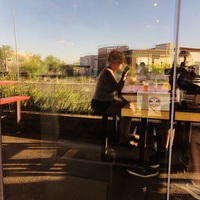 Photo of a woman drinking outside at a restaurant.