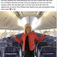 A flight attendant stands in front of empty plane seats. 