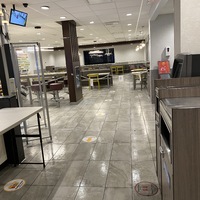 This is a picture taken of a very empty McDonald's restaurant. 