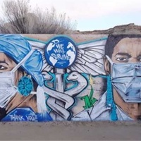 This is a picture of a mural on a wall which depicts two front line medial workers wearing face masks, with a caduceus in between them. The globe on the caduceus has the words "We Will survive" painted on it, and a message on the bottom of the mural reads "Thank you !!". 