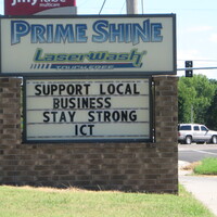 A sign saying "Support Local Business Stay Strong ICT".