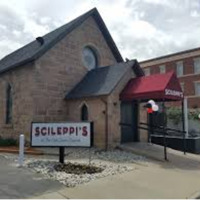 A picture taken of the outside of a stone church converted into a pizza restaurant in Colorado. 