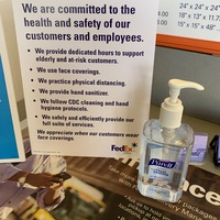 Image of a FedEx sign that says we are committed to the health and safety of our customers and employees. We provide dedicated hours to support elderly and at-risk customers. We use face coverings. We practice physical distancing. We provide hand sanitizer. We follow CDC cleaning and hand hygiene protocols. We safely and efficiently provide our full suite of services.  