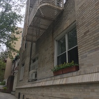 The front of brick buildings facing the sidewalk. 