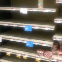 This is a photo of a mostly empty grocery store shelf at the beginning of the COVID-19 pandemic. 