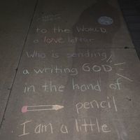 The words "I am a little pencil in the hands of a writing God, who is sending a love letter to the world. -Mother Teresa" written on a sidewalk in chalk. 