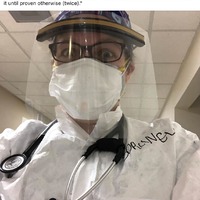 A doctor wearing a mask and protective gear. 