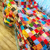 This is a picture of a large, multicolored quilt that a person created during the COVID-19 Pandemic lock down. 