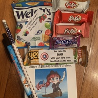 This is a picture taken of a group of snacks that were from a gift bag. Several encouraging messages are also found on slips of paper mixed with the snacks. 