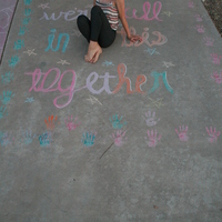 A person sitting in a chalk drawing. 