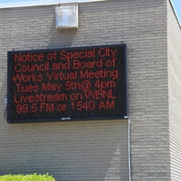 Digital Sign reading "Notice of special City council and board of works virtual meeting Tues May 5th at 4 pm. Livestream on WBNL 99.5 FM or 1540 AM".