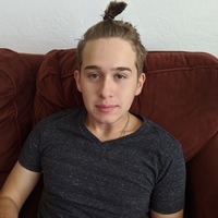 A picture of a person with their hair in a bun. 