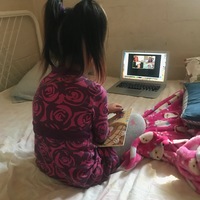 Picture of a young child on a Zoom call on a computer.