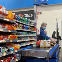 A masked cashier at a Walmart.