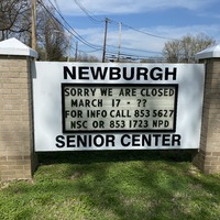 A sign outside a senior center reading "Sorry We Are Closed March 17 Through ?? For More Info Call 853-5627 NSC or 853 1723 NPD".