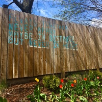 A message painted on a fence meant to brighten the day of the reader that says "Always Together, Never Apart, Maybe In Distance, But Never In Heart". 