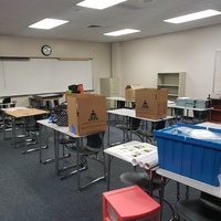 Boxes on tables in a classroom. 