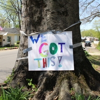 A paper sign reading "We got this".