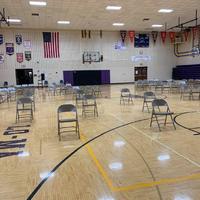 Image of chairs spread out in a school gym for graduation.