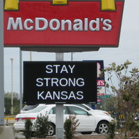 A sign under a McDonald sign stay "stay strong Kansas" 