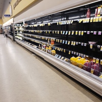 Image of a mostly empty shelf in a grocery store.