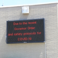 Business sign reading "Due to the recent Governor Order and Safety Protocols for COVID-19".