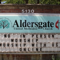 Sign at Aldersgate United Methodist Church reading "No in person worship. Worship with us online".